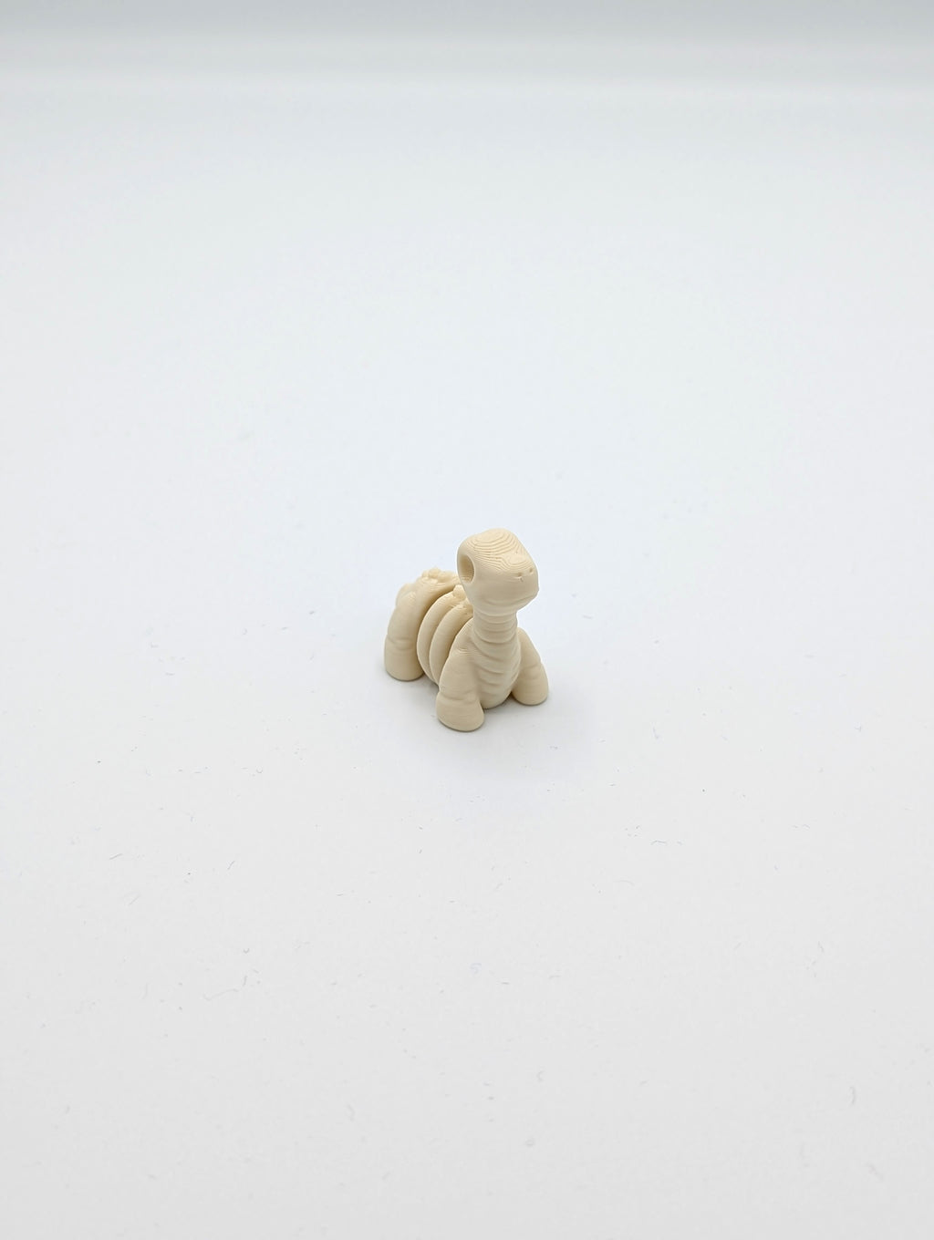 Mini fidget de brontosaurio esqueleto fósil
